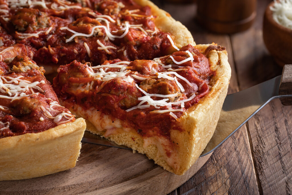The Finer Things in Life - deep dish pizza on a wooden serving plate